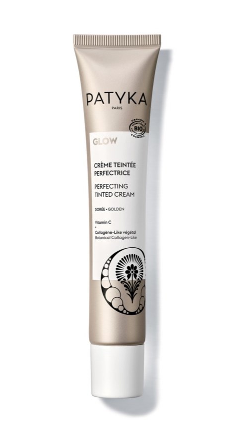Een tube van Patyka Glow Perfecting Tinted Cream met een bloemenpatroon onderaan.