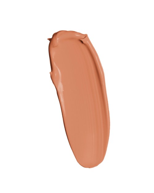 Eén vlek beige of lichtbruin make-up of crème op een witte achtergrond.