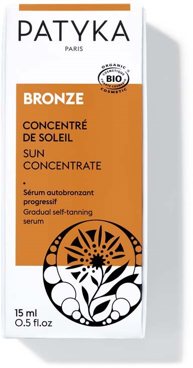 Een doosje Patyka Zonneconcentratie met oranje en witte verpakking, met een zwart-wit bloemenontwerp.