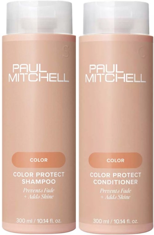 Two pink bottles of Paul Mitchell hair care products, one shampoo and one conditioner, stand side by side.