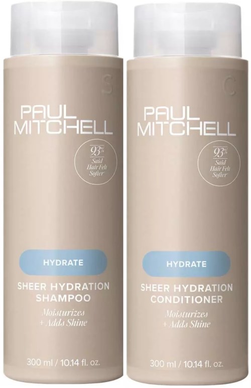 Kaksi beigenväristä hiustenhoitopulloa, labelinä 'Paul Mitchell', toinen shampoolle ja toinen hoitoaineelle, sinisillä tarroilla.