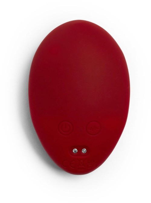 Ein rotes, ovalförmiges Gerät mit Tasten und kleinen Metallkontakten auf einer Seite.