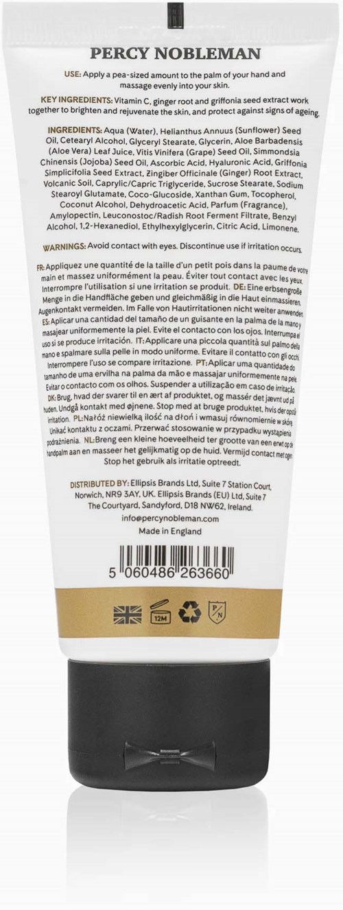 The back of a white tube with black cap shows ingredients, warnings, and barcode, including a gold band near the bottom.
