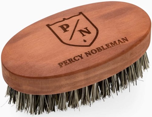 A wooden shoe brush with metal bristles and a logo reading "Percy Nobleman" and "P/N" on top.