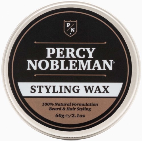 A round container of Percy Nobleman styling wax with black, white, and pink colors, used for hair and beard styling.