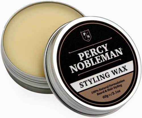 A round tin container with black and white label for Percy Nobleman styling wax, showing the lid and some wax inside.