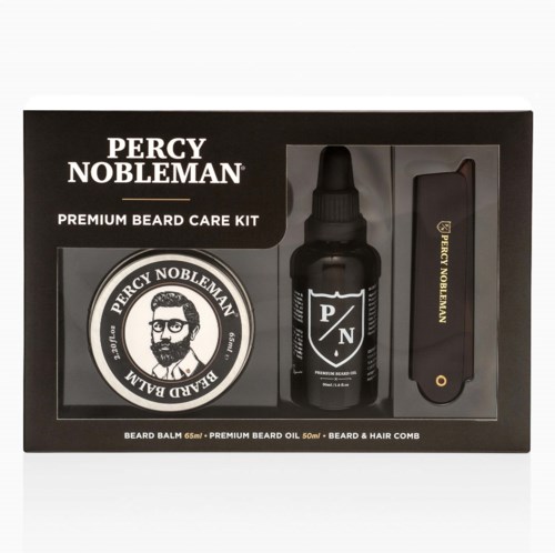 A Percy Nobleman beard care kit with beard balm, beard oil, and a comb in black packaging.
