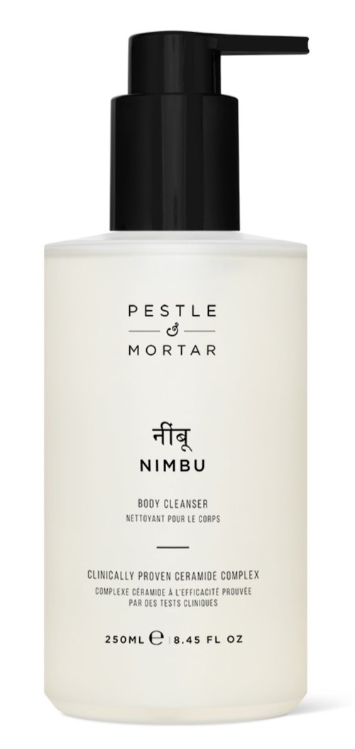 Een witte fles met een zwarte pomp met label 'Pestle & Mortar Nimbus Body Cleanser'.