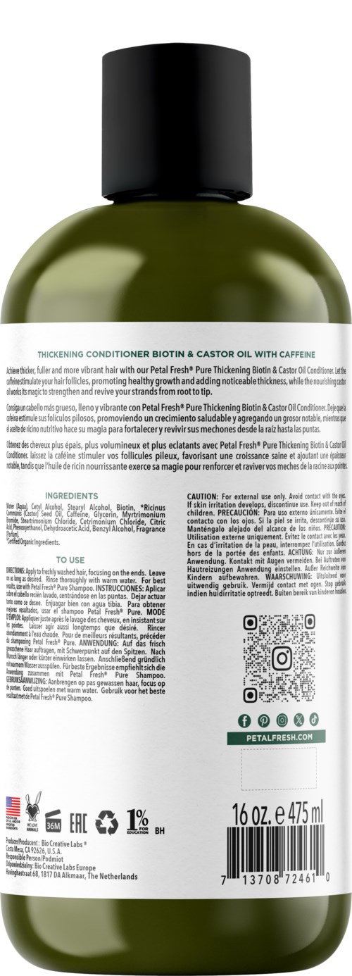 A green bottle with a black cap, label with text, QR code, and bar code, likely a hair or skincare product.