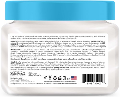 A jar of skincare cream with a blue lid, labeled as containing Niacinamide, Chamomile, and other ingredients for skin soothing.