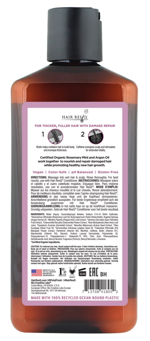 A brown bottle with a black cap, featuring a pink and white label with text and instructions.