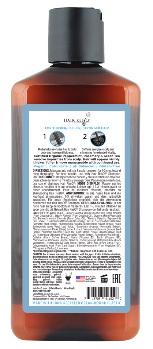 This is a bottle of hair treatment or shampoo with a blue label and black cap.
