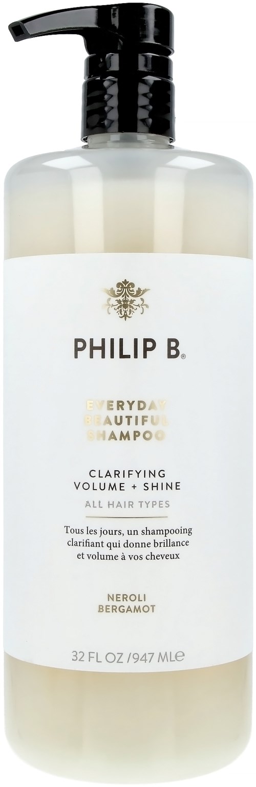 Eine weiße Shampoo-Flasche mit schwarzem Pumpkopf, beschriftet 'Philip B', für Volumen und Glanz aller Haartypen.