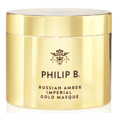 Ein goldfarbener Behälter mit Philip B. Russian Amber Imperial Gold Masque. Elegante Verpackung mit schwarzem Text und Logo.