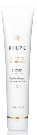 Eine weiße Tube von Philip B. mit Goldakzenten, als Hydrating Detangler für alle Haartypen gekennzeichnet.