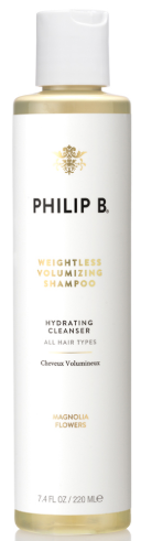 Eine kleine weiße Flasche mit Philip B auf dem Etikett, Gold- und Schwarzt individuell. Es ist Shampoo für alle Haartypen.
