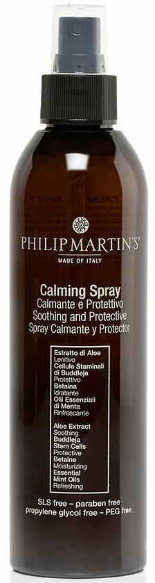 A brown spray bottle with a black spray top, labeled 'Philip Martin's Calming Spray,' contains soothing and protective ingredients.