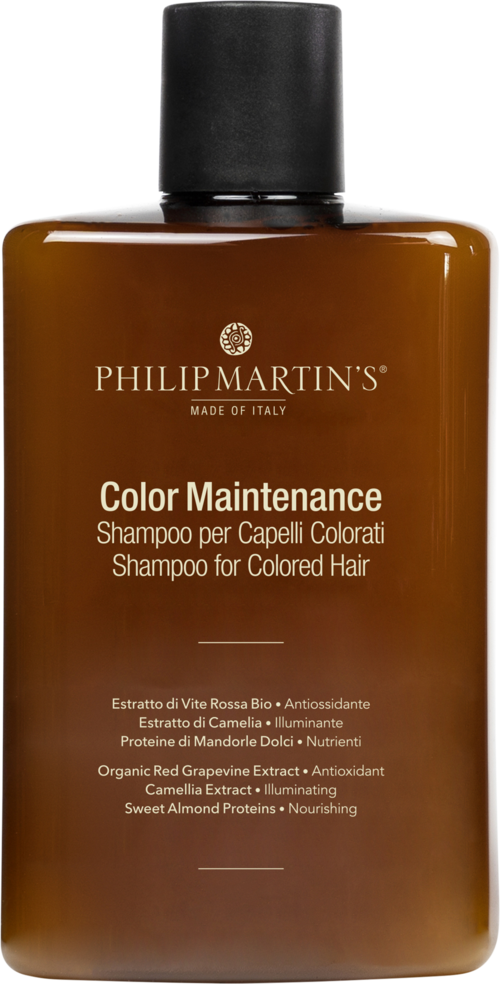 En brun flaske med svart lokk, merket 'Color Maintenance' sjampo for farget hår, med tekst på flere språk.