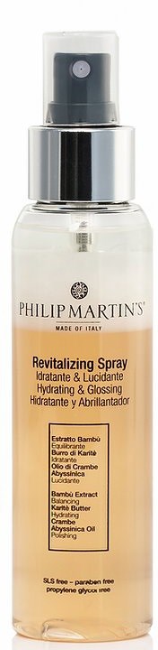 A clear spray bottle labeled 'Revitalizing Spray' with a black nozzle and silver collar, containing a skin product.