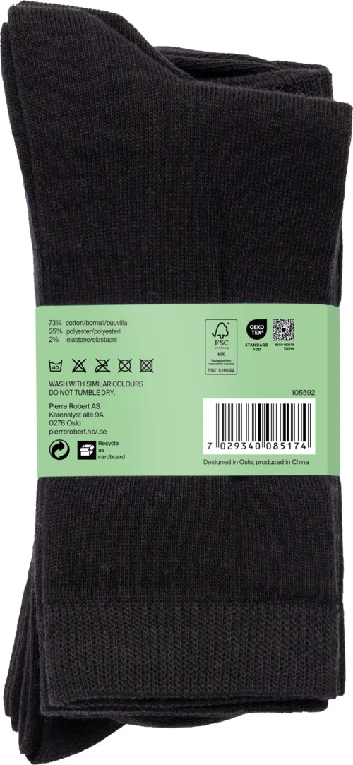 Black socks with a green label wrapped around, containing text and symbols. The socks are folded.