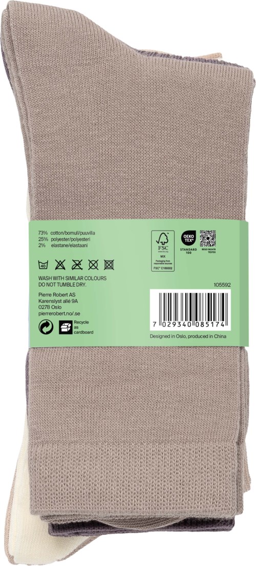 A pair of beige socks with a green label wrapped around them, including care instructions and barcode.