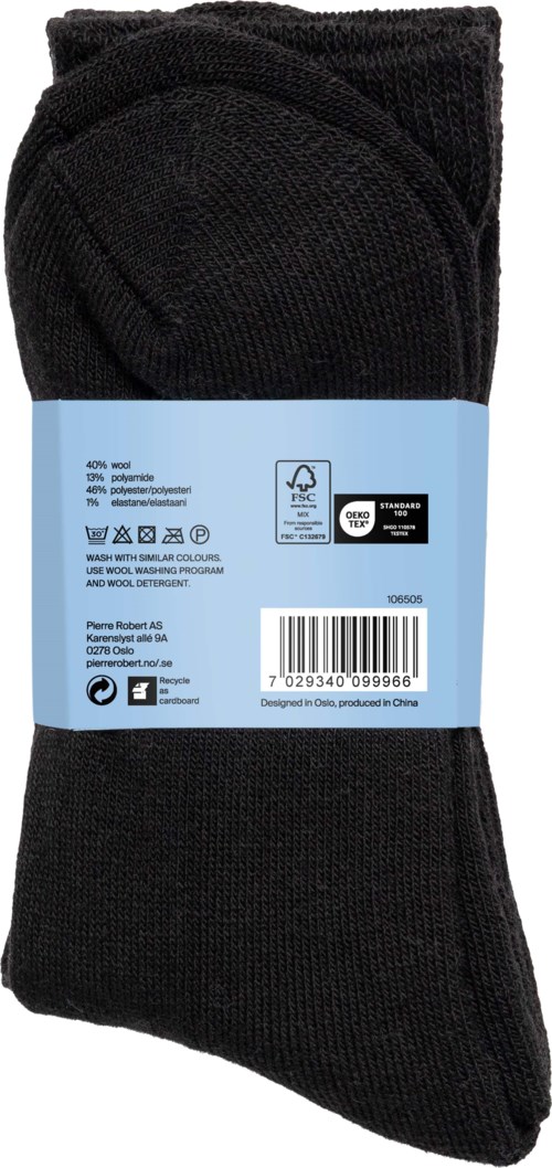 A pair of black socks, folded and wrapped with a blue label showing care symbols and barcode.