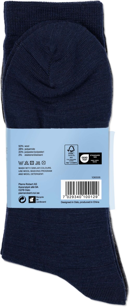 A pair of dark blue socks with a light blue label showing product information and barcode.