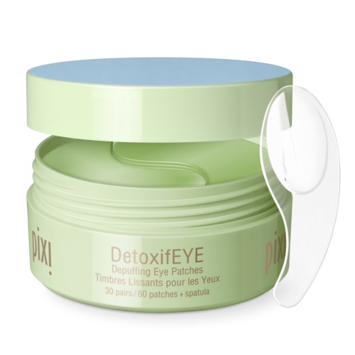 Groene container met oogmaskers en een doorzichtige spatel ernaast. Label zegt DetoxifEYE voor het verminderen van zwelling en kalmeren van de ogen.