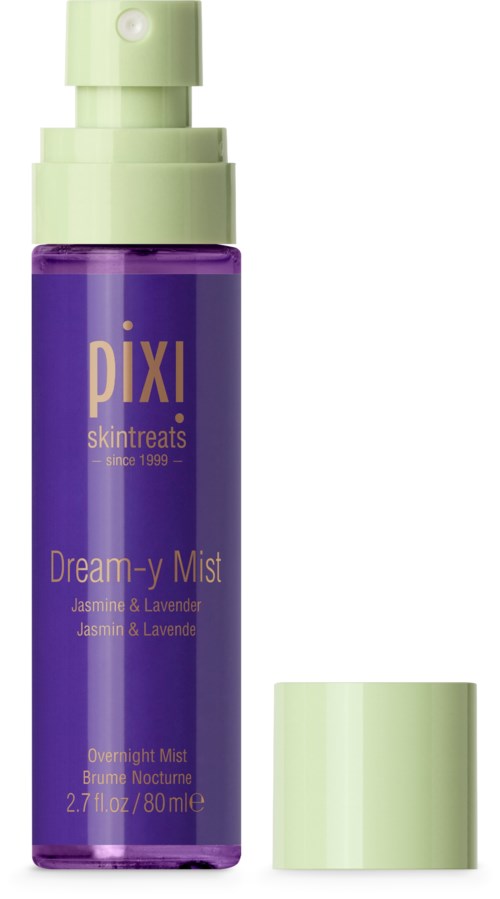 A purple bottle with a green cap and spray nozzle, labeled 'Dream-y Mist' with jasmine and lavender scent.