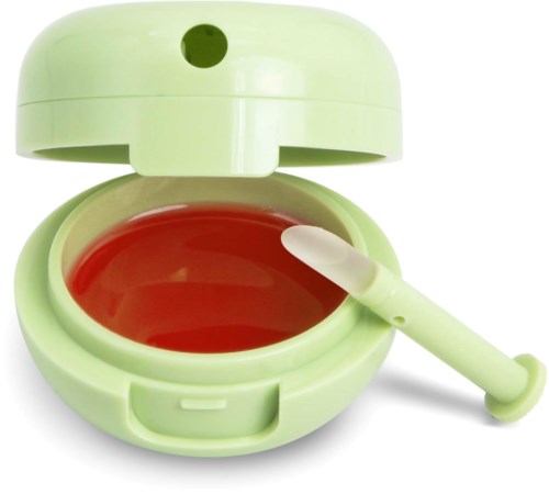 A small green container with lid, opening to red liquid with a white tool inside, looks like a toy or a makeup case.