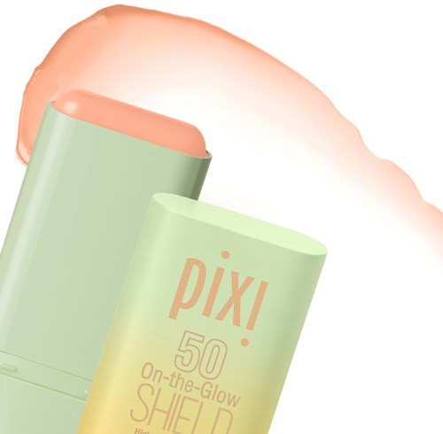 A green tube of Pixi skincare with a peach-colored product coming out. The tube shows the brand and product details.