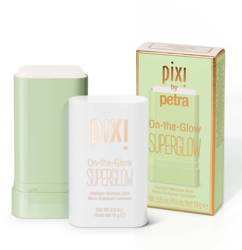 A green and white portable skincare stick with packaging, called PIXI On-the-Go Superglow, designed for brightening skin.