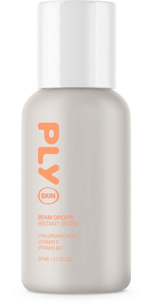 Een witte fles met oranje tekst die 'PLAY' zegt en huid, glow en vitamines noemt.