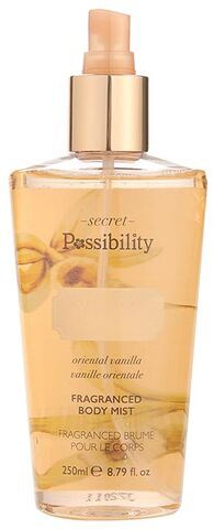 Een gouden sprayfles voor body mist met een gouden dop, gelabeld 'Secret Possibility' en vanillegeur.