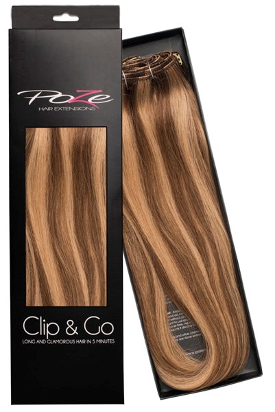 A boxed hair extension with long, straight, blonde-brown hair. The package is black with words and a window showing the hair.