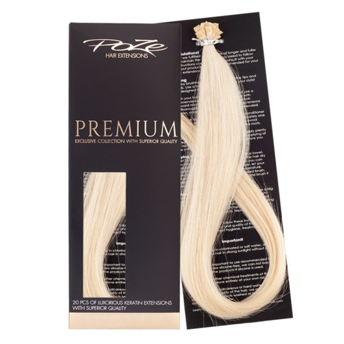 Blonder hårförlängning på svart och beige förpackning, märkt som premium, med 20 bitar inuti.