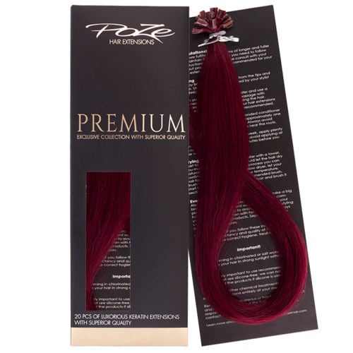 En svart förpackning säger 'Foxy Hair Extensions Premium' med ett prov på rött hårtillsats fäst.