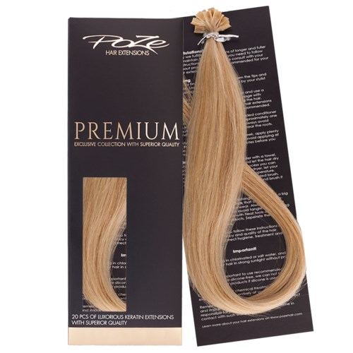 En blond hårförlängning fastsatt på svart förpackning med texten "Premium" och ett litet hårprov.