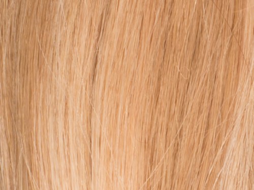 Close-up van blond haar, glad en glanzend met natuurlijke lichtreflectie.