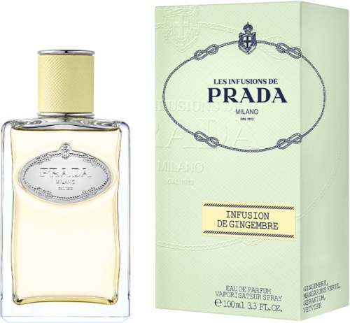 Een parfumfles en een lichtgroene doos met blauwe en gouden tekst voor Prada gemberinfusie geur.