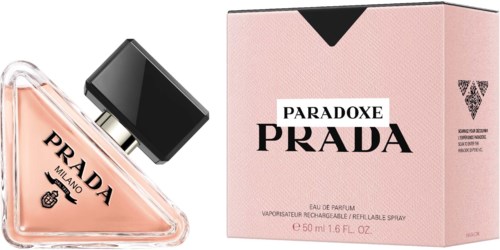 A Prada perfume bottle and pink box with black and white labels and text.
