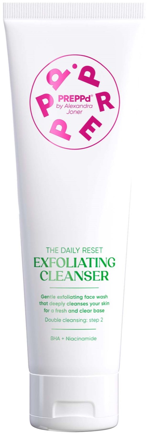 A white tube with pink and green text, promoting an exfoliating face cleanser for skin renewal.