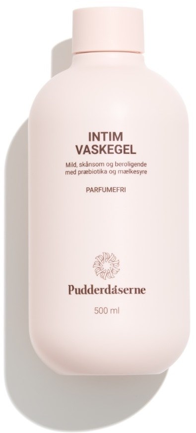 En hvit flaske med rosa lokk, merket på dansk som en mild intimvask med naturlige ingredienser.