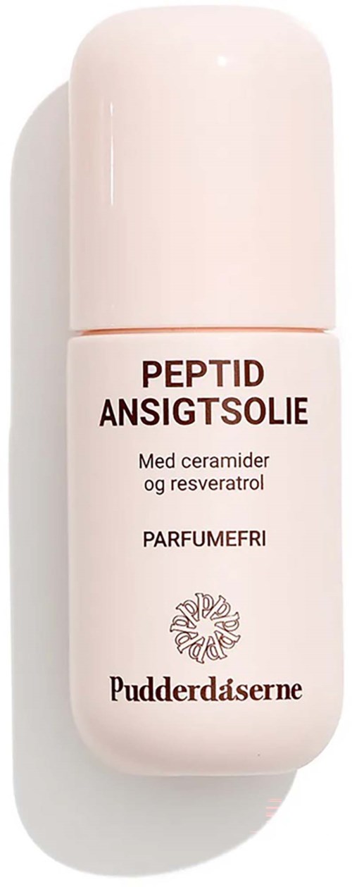 En hvit flaske med Peptide Ansiktsolje med mykt rosa lokk, merket med produktnavn og ingredienser.