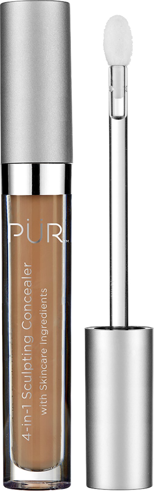 En concealer i ett genomskinligt rör med en silverlock och en applikator med vinge. Produktnamnet står på röret.