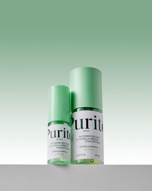 Two skincare bottles with green caps and labels stand on a surface against a green gradient background.