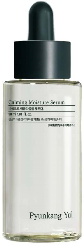 A clear glass bottle with a black dropper cap, labeled "Calming Moisture Serum" and 