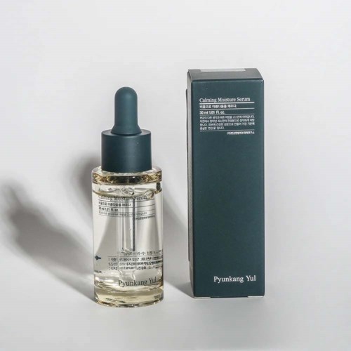 A skincare serum bottle with a dropper next to its box, labeled 'Calming Moisture Serum' by Pyunkang Yul.