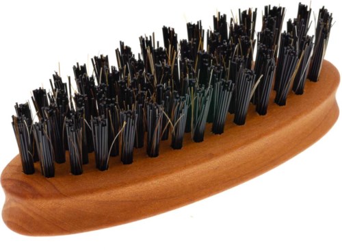 A wooden brush with black bristles, some are straight, others are bent, used for cleaning or massaging.