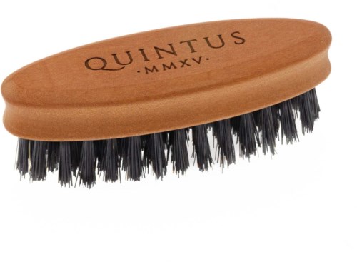 A wooden shoe brush with black bristles and the word 'QUINTUS' engraved on it.